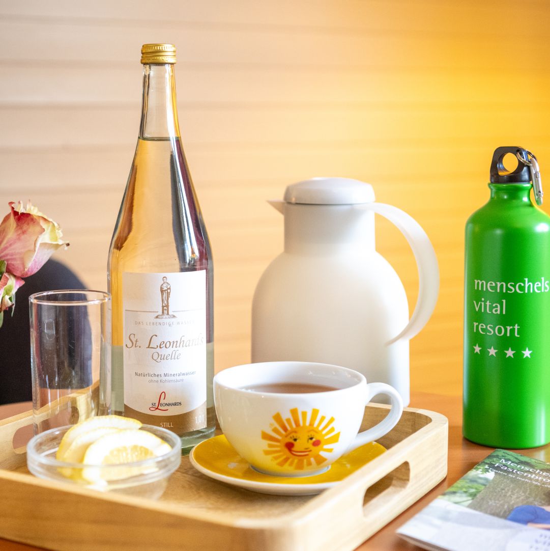 Breakfast tray with water bottle, sunny teacup, and green water flask