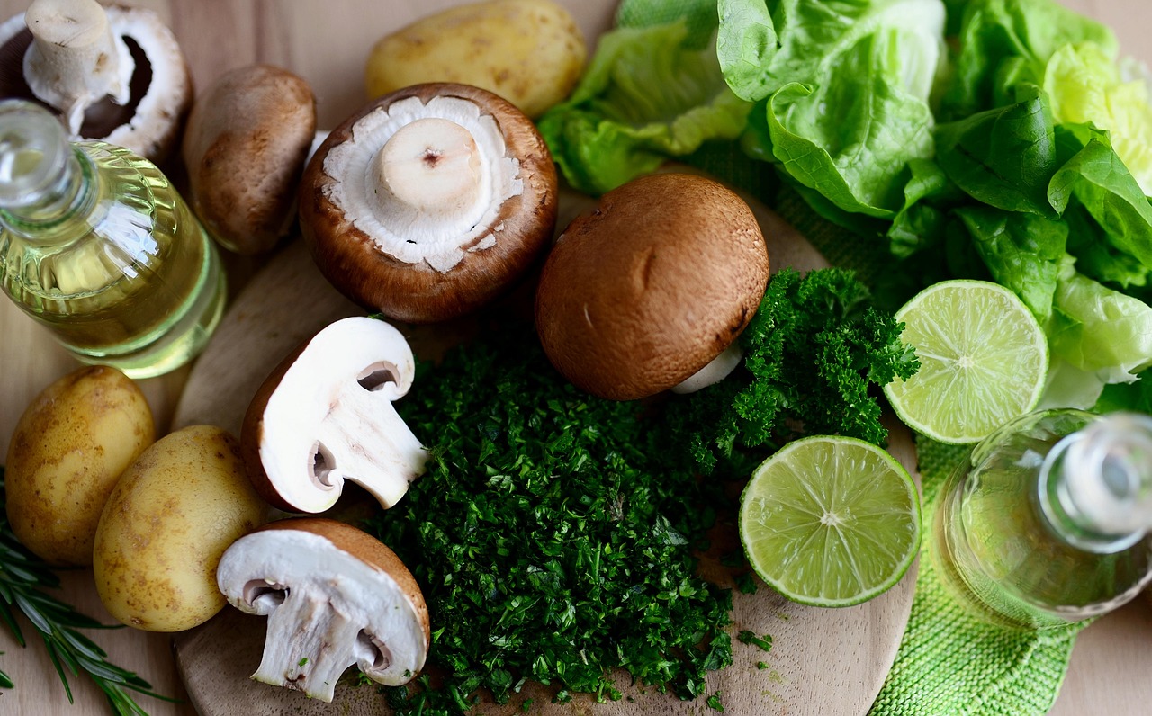 Fresh ingredients including mushrooms, potatoes, limes, lettuce, and herbs