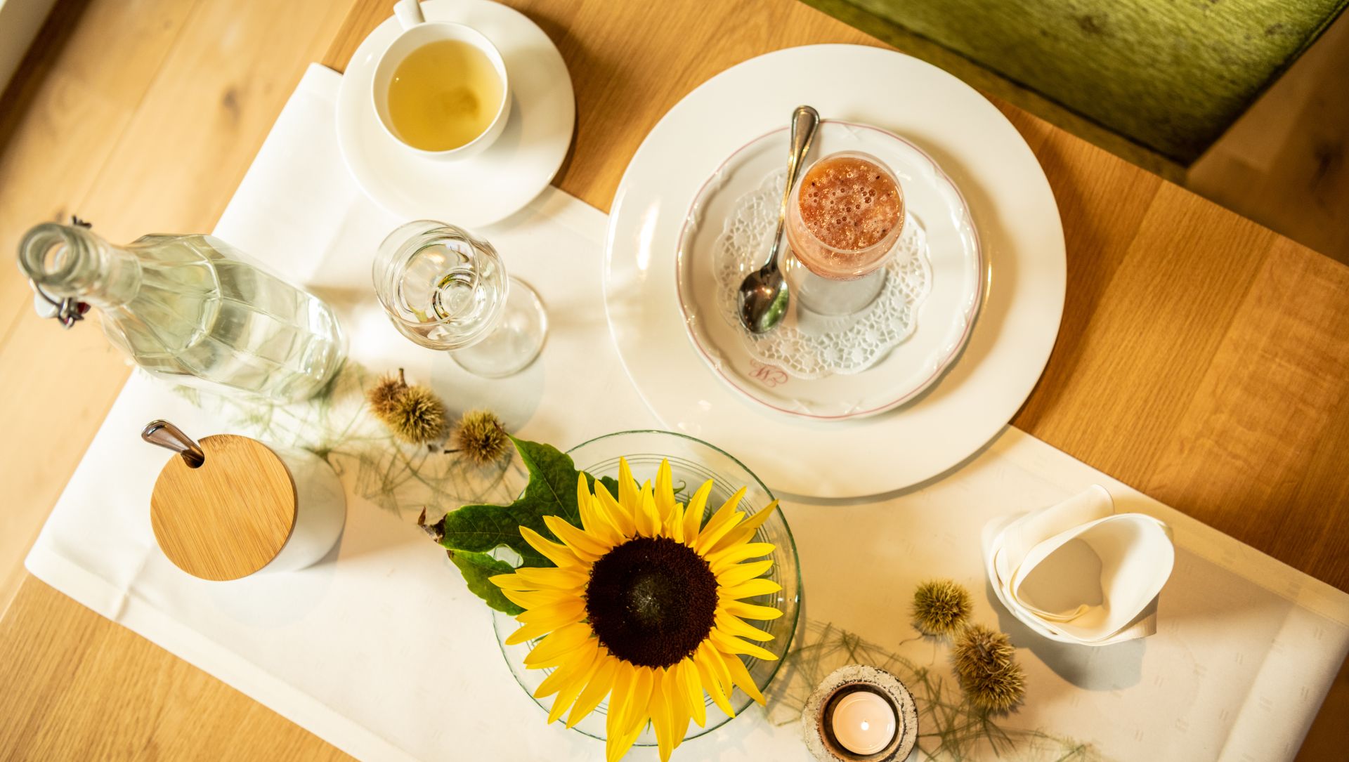 Sunflower and coffee table setting with glasses, tea, and rustic decor
