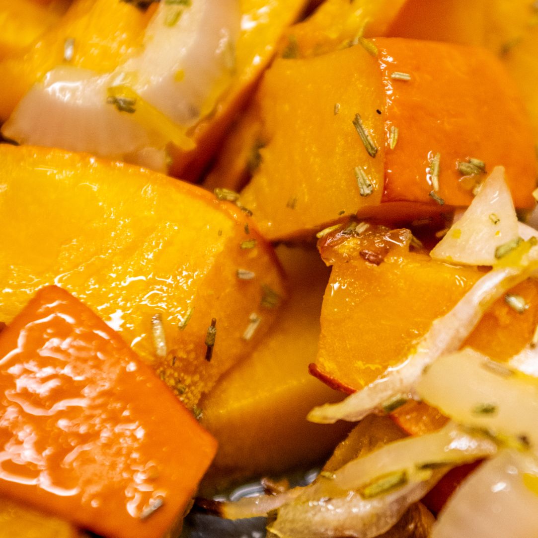 Roasted butternut squash chunks with herbs, close-up view