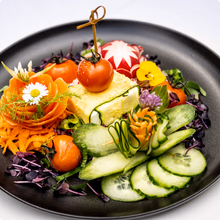 Colorful gourmet salad with fresh vegetables, tomatoes, and edible flowers