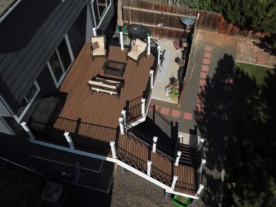 Aerial view of a brown Trex composite deck with black railings and stairs