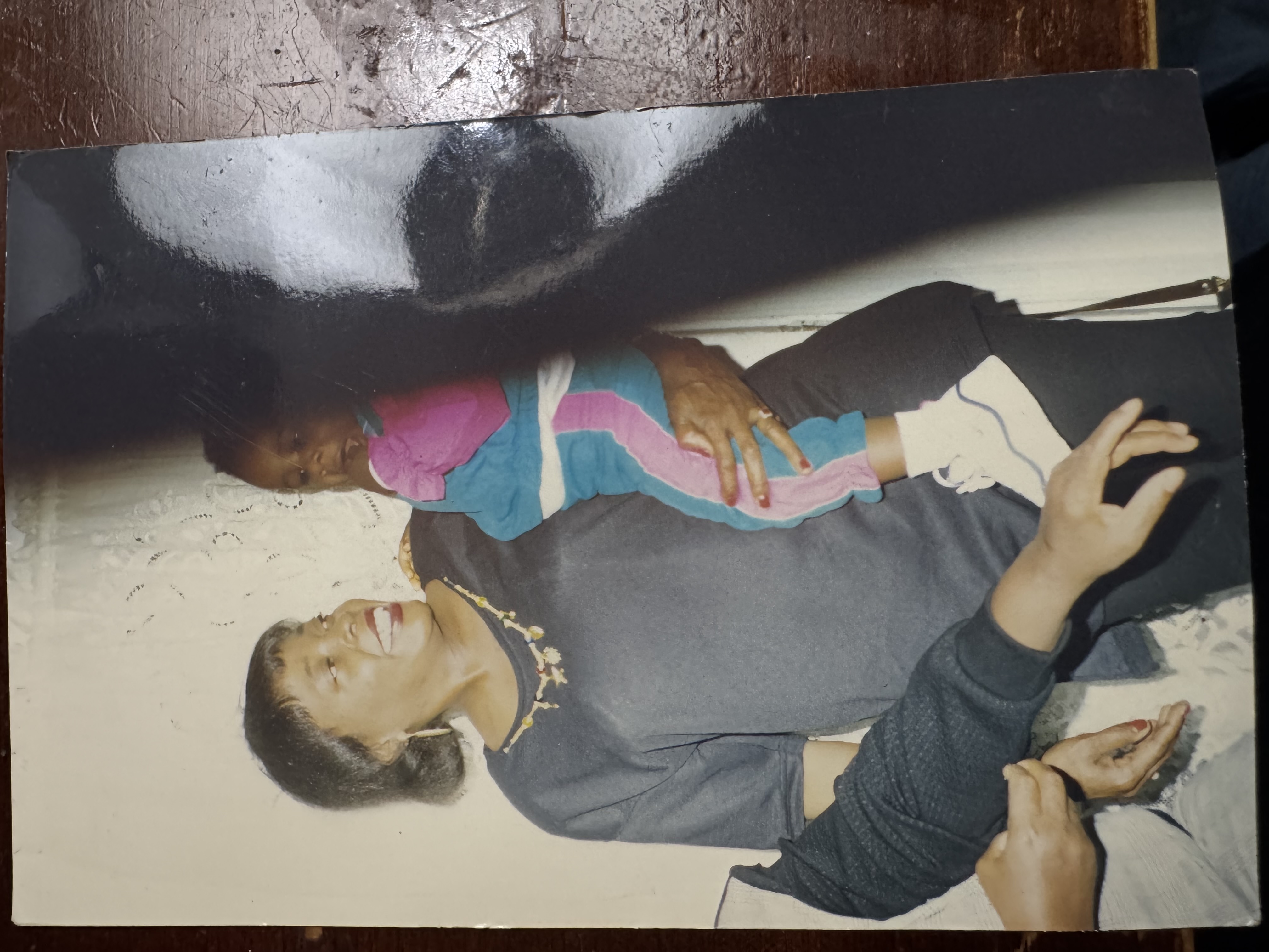 A printed photograph with a grandma holding a young child on her hip