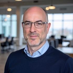 A person wearing glasses and a blue shirtAI-generated content may be incorrect.