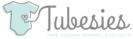 Tubesies logo with a light blue onesie on the left side of the image and the brand name written in cursive on the right side. Below the brand name reads "TUBE FEEDING FRIENDLY BODYSUITS".