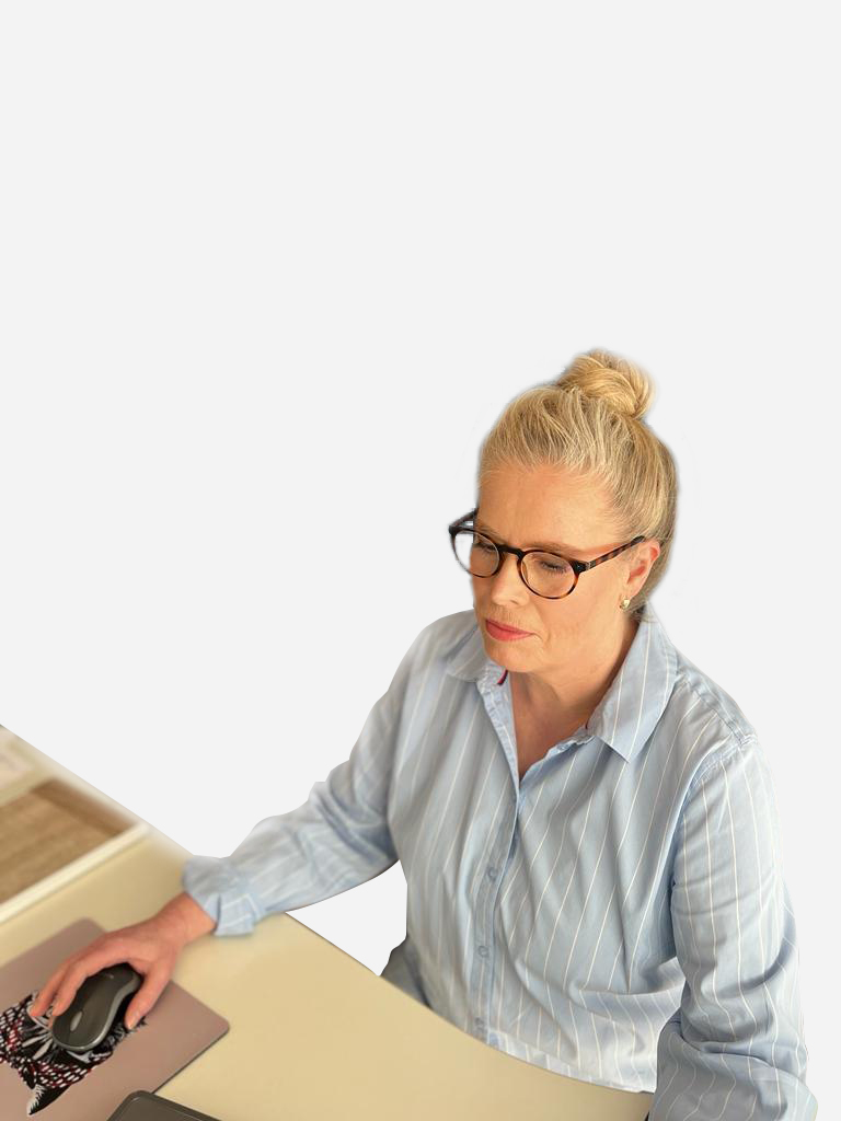 Inge Wiesner arbeitet am Laptop und sitzt am Schreibtisch