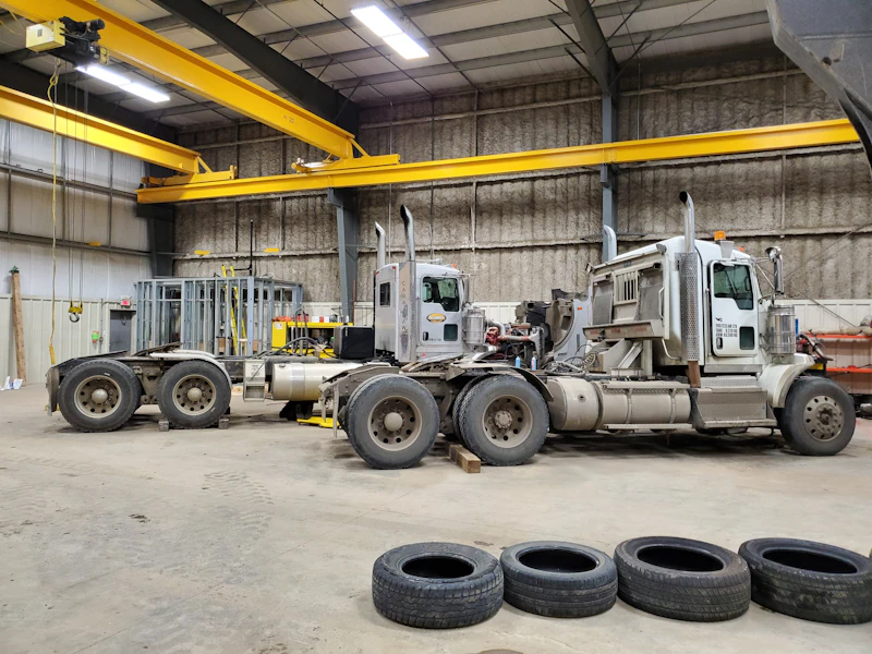 sideview of trucks and tires in a repair shop