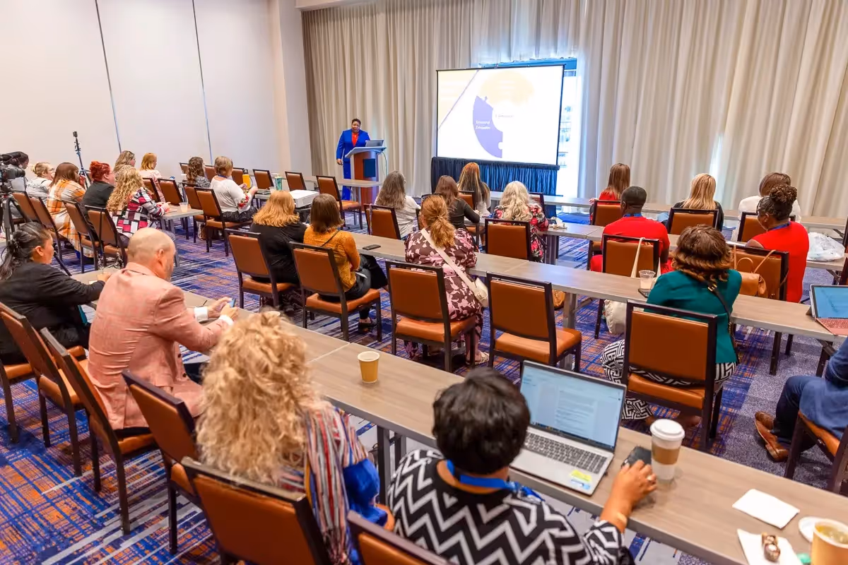 Burnout Coach Dr Brandy Biglow speaking at Integrative Health conference wide shot