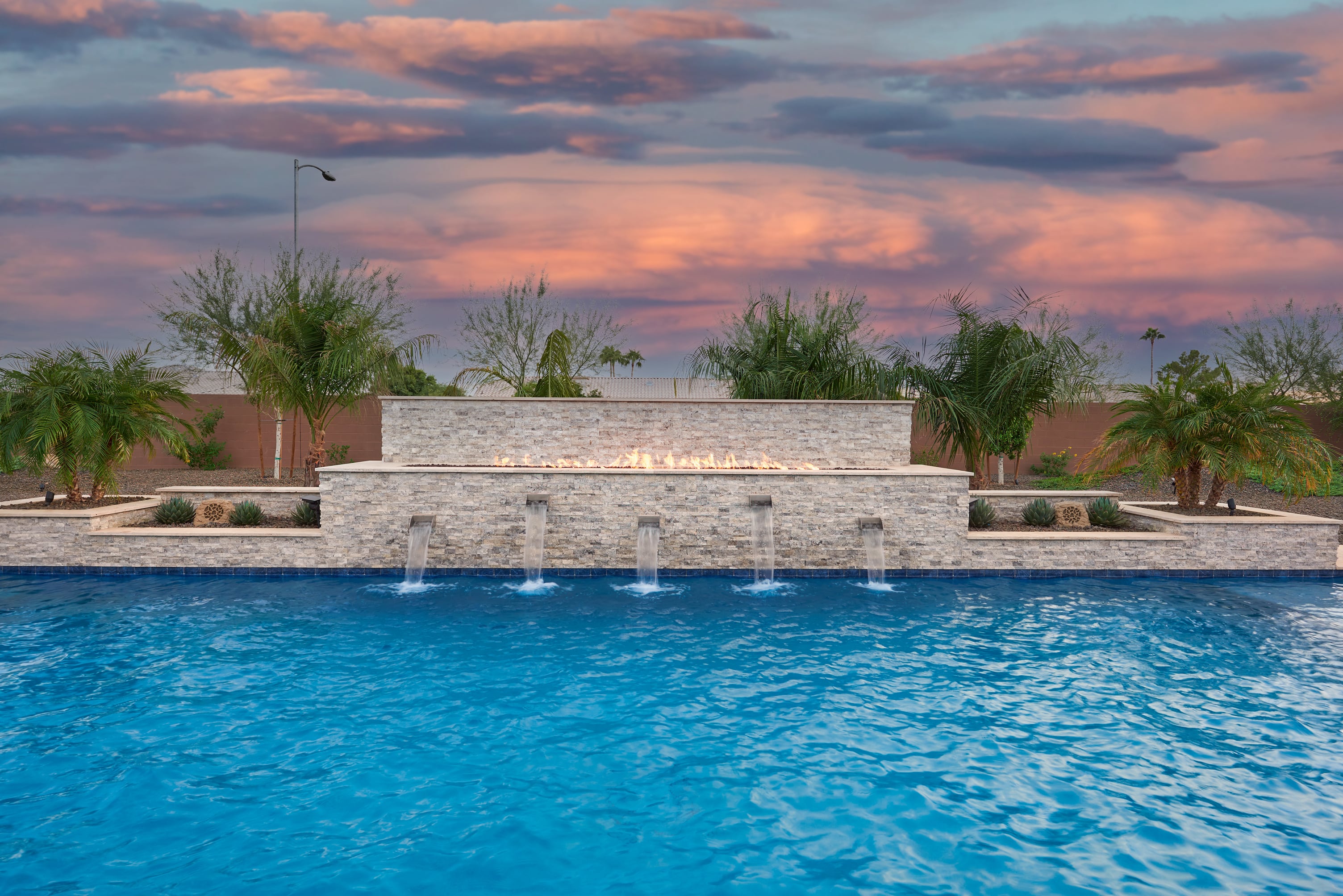 Pool with water scuppers and fire features