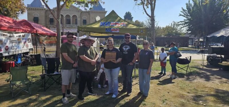 Five deputies and K9 in front of flag