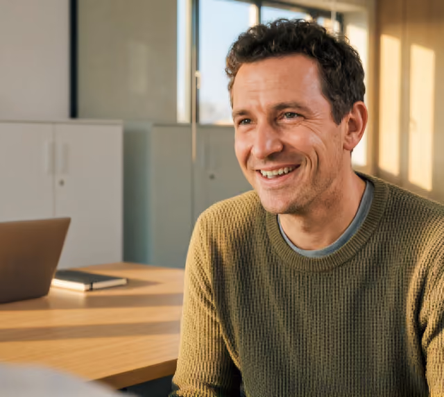 A man wearing green t-shirt with a smile