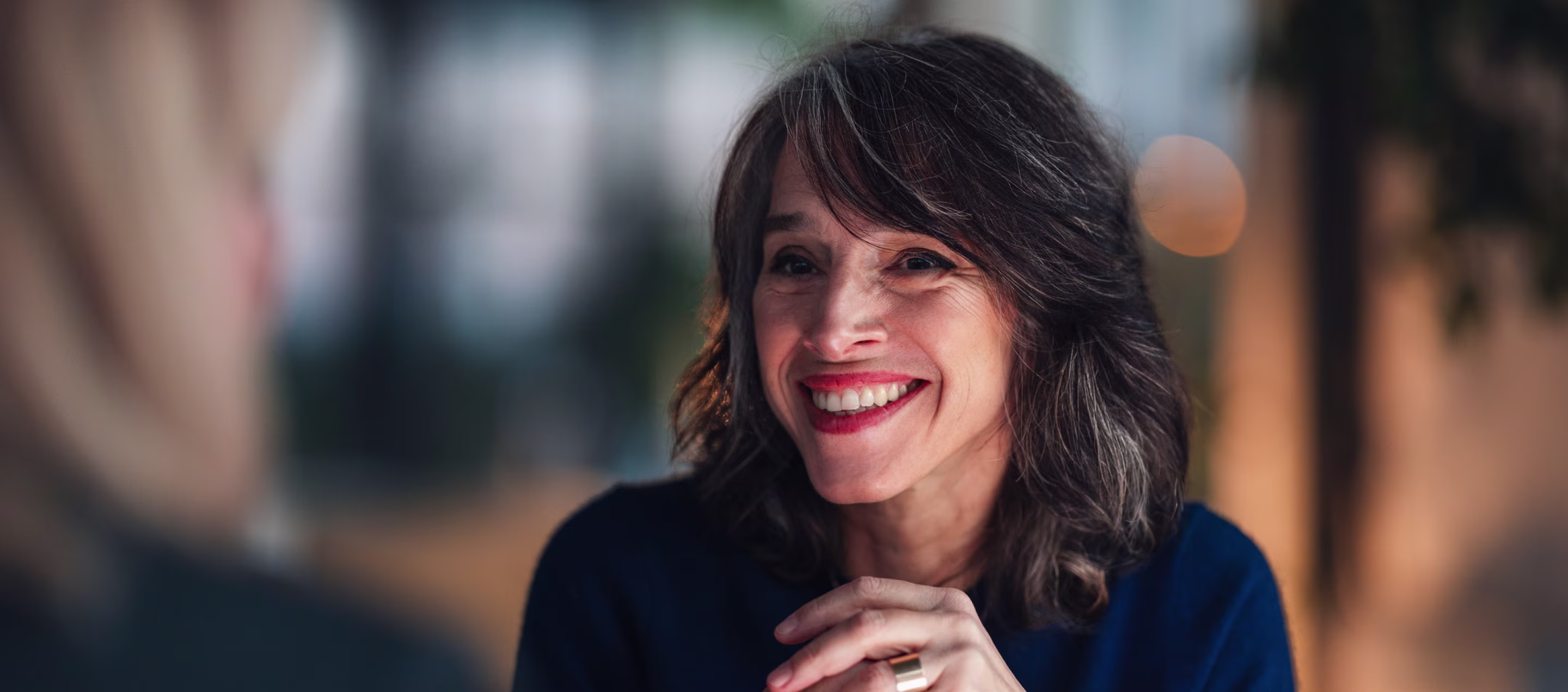 A woman smiling while talking
