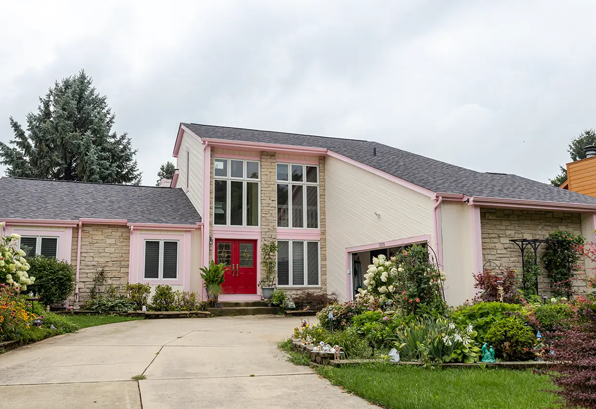 Home with pink accents and white siding.