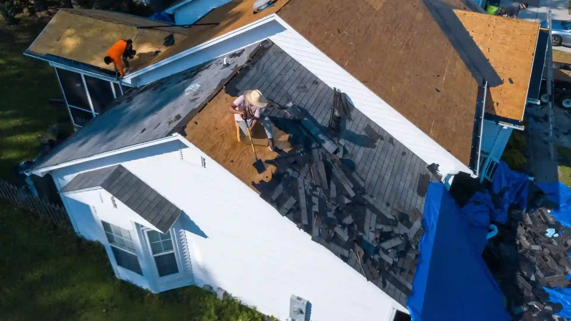A house with a roofing contractor on replacing the roof