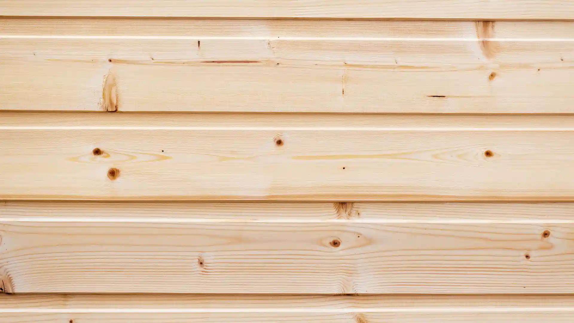 Textured pine wood siding planks of off-white color