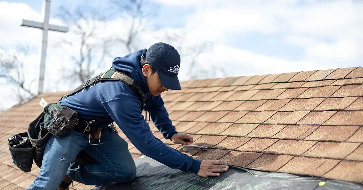 Roofing expert tarping roof.