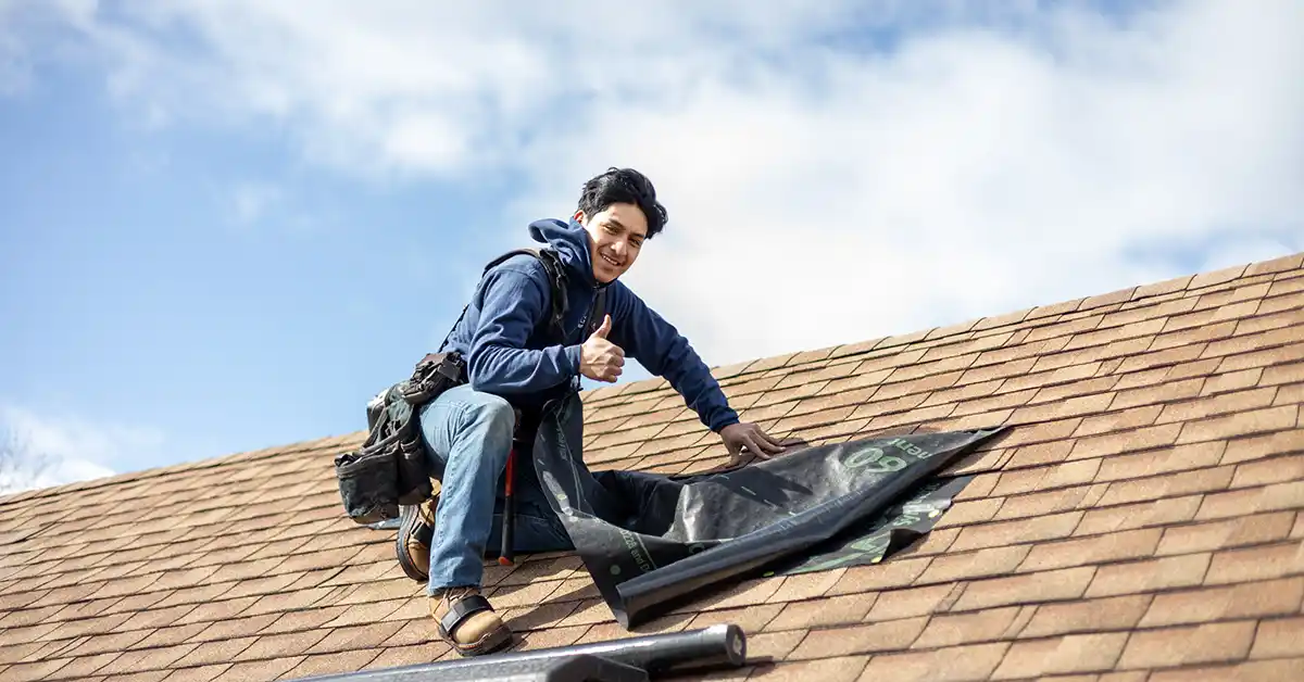 Global Exterior Experts team member tarping roofing.