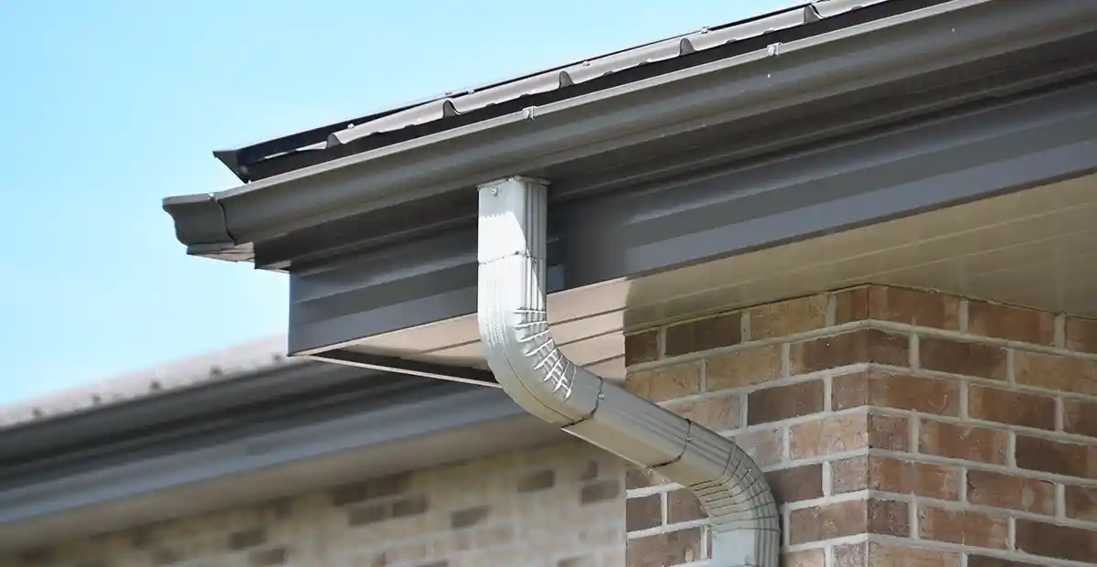 Dark aluminum fascia behind a gutter.