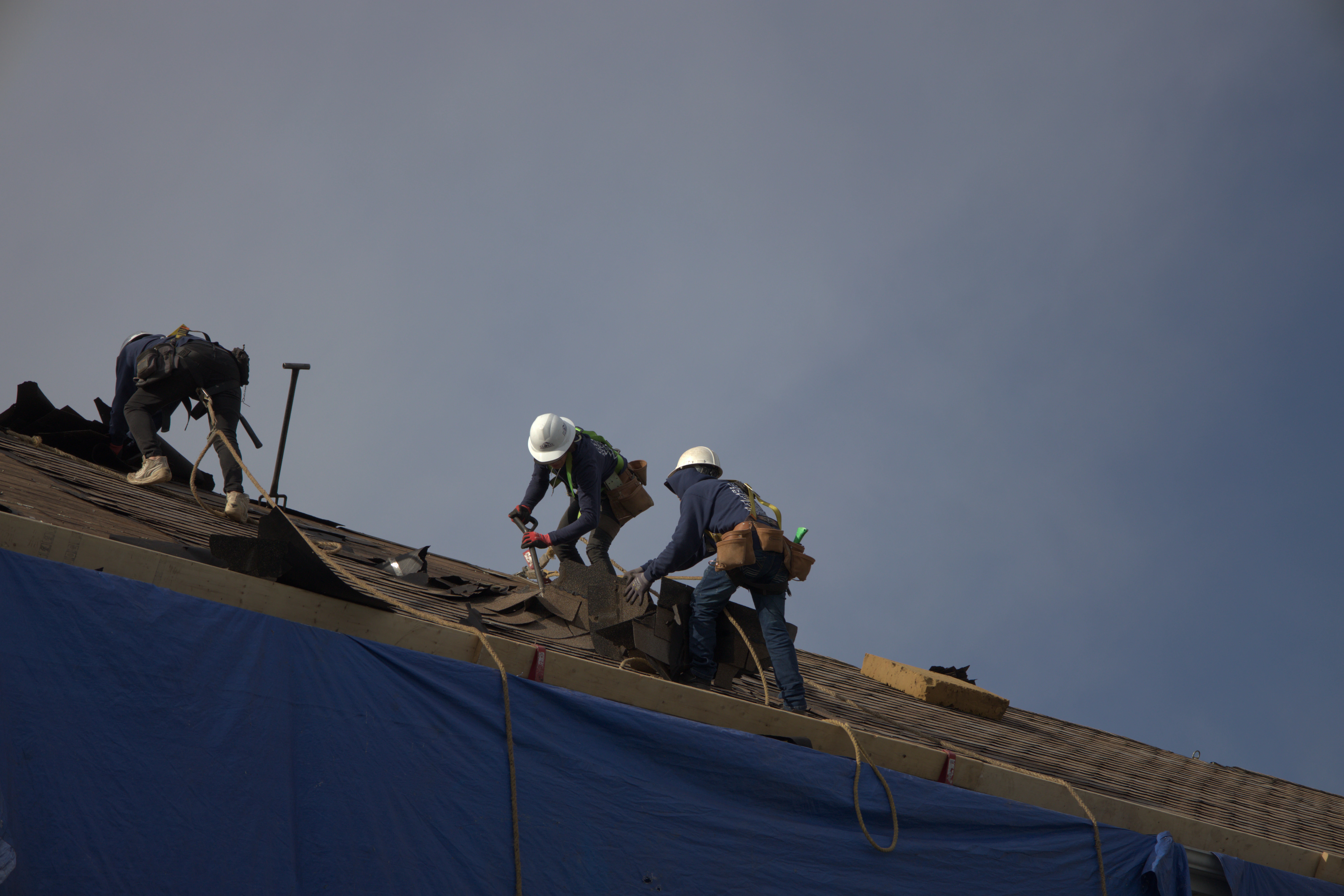 Global Exterior Experts Roofers Tearing Off Roof From Residential Home
