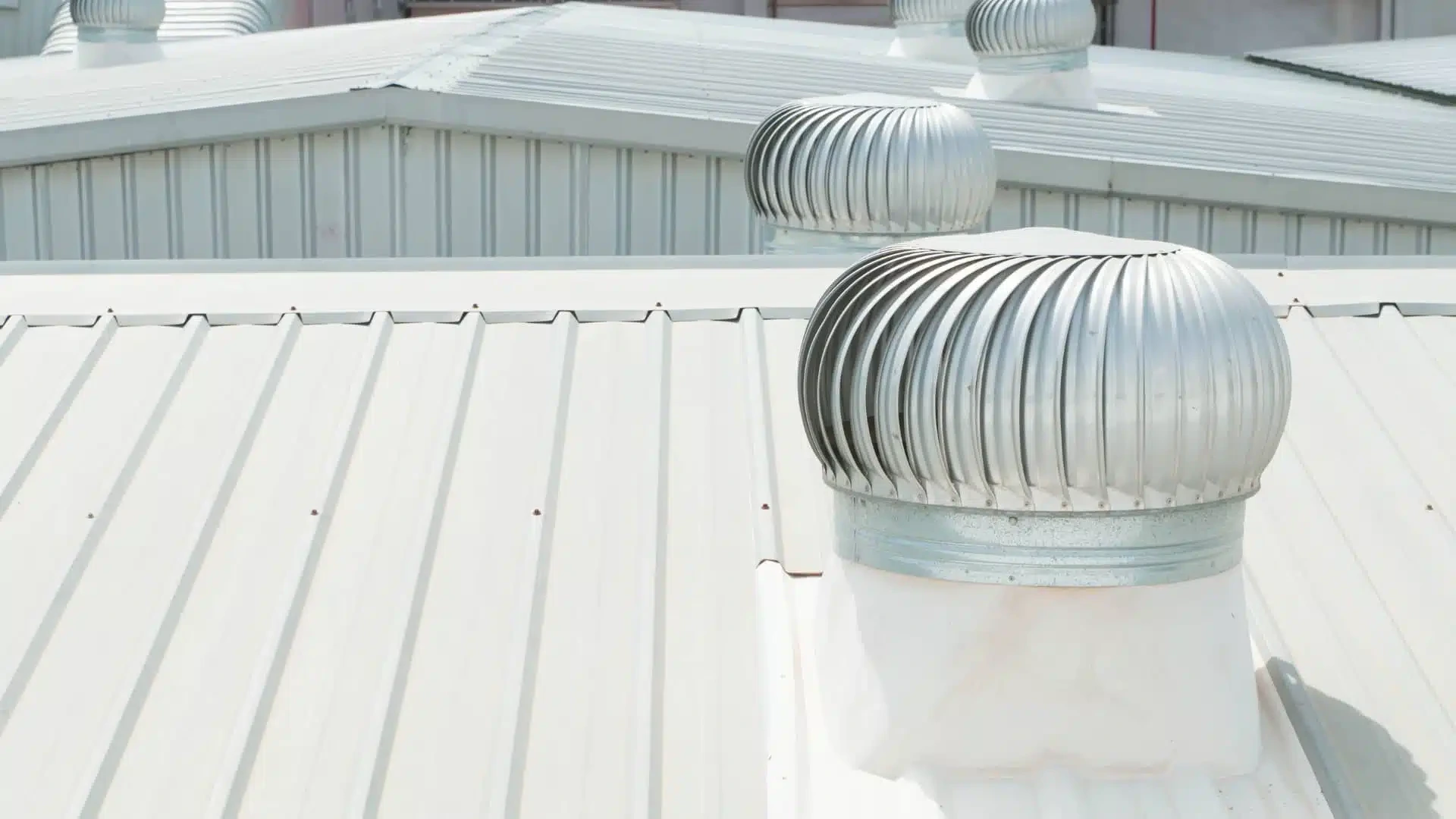 White Metal Commercial Roof With Visible Fan Penetrations