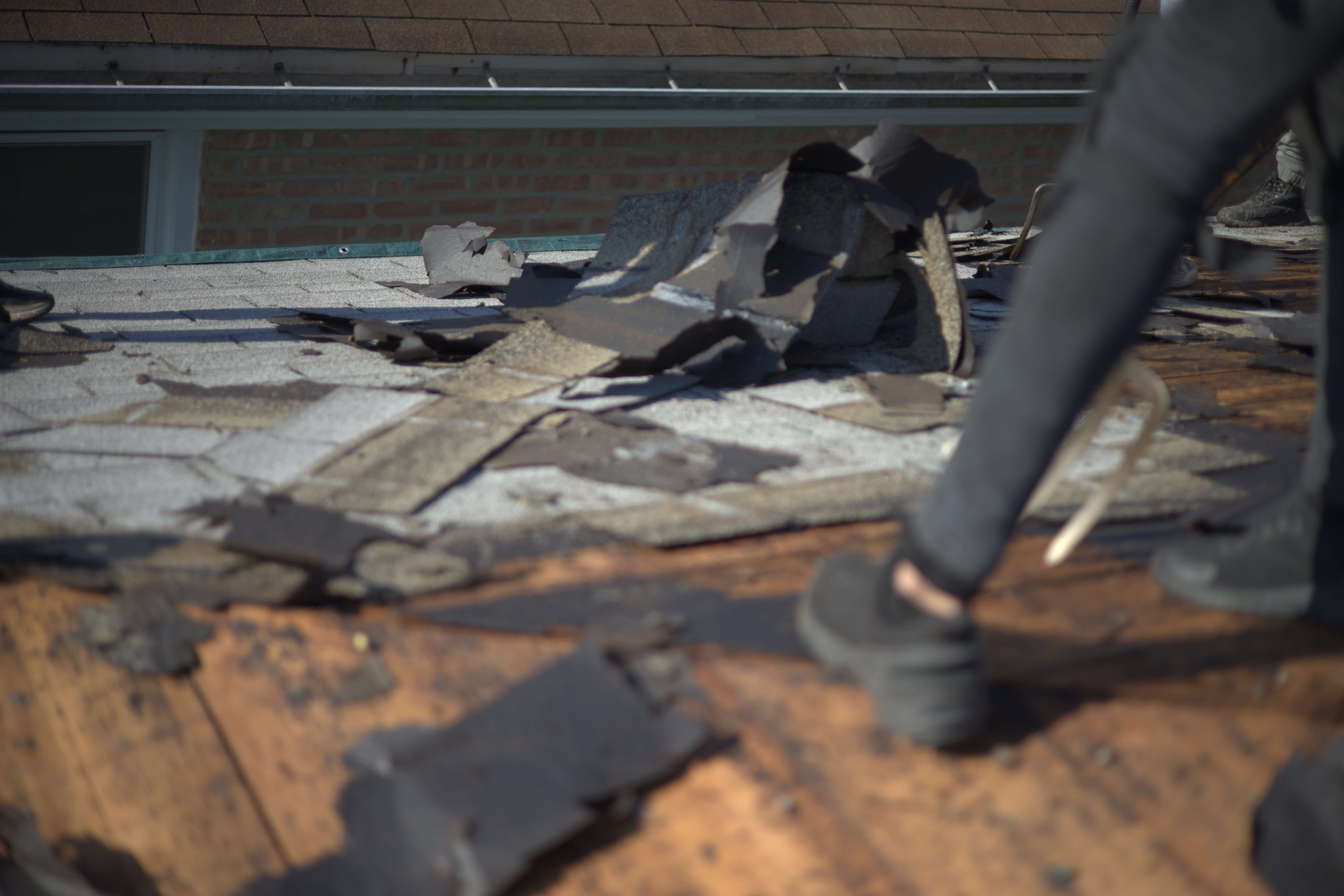 Tearing Off Old Shingles On Residential Roof | Global Exter