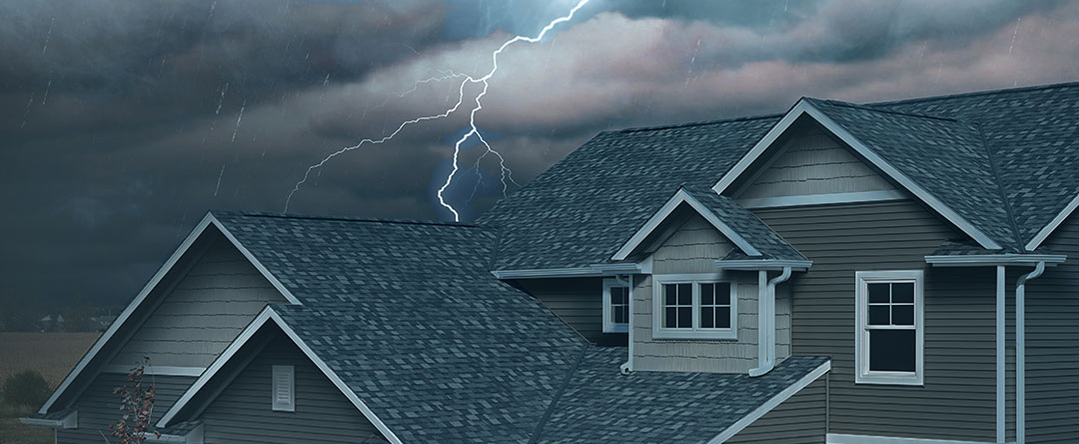 Residential Roof Experiencing Extreme Weather With Lighting Strike Behind It
