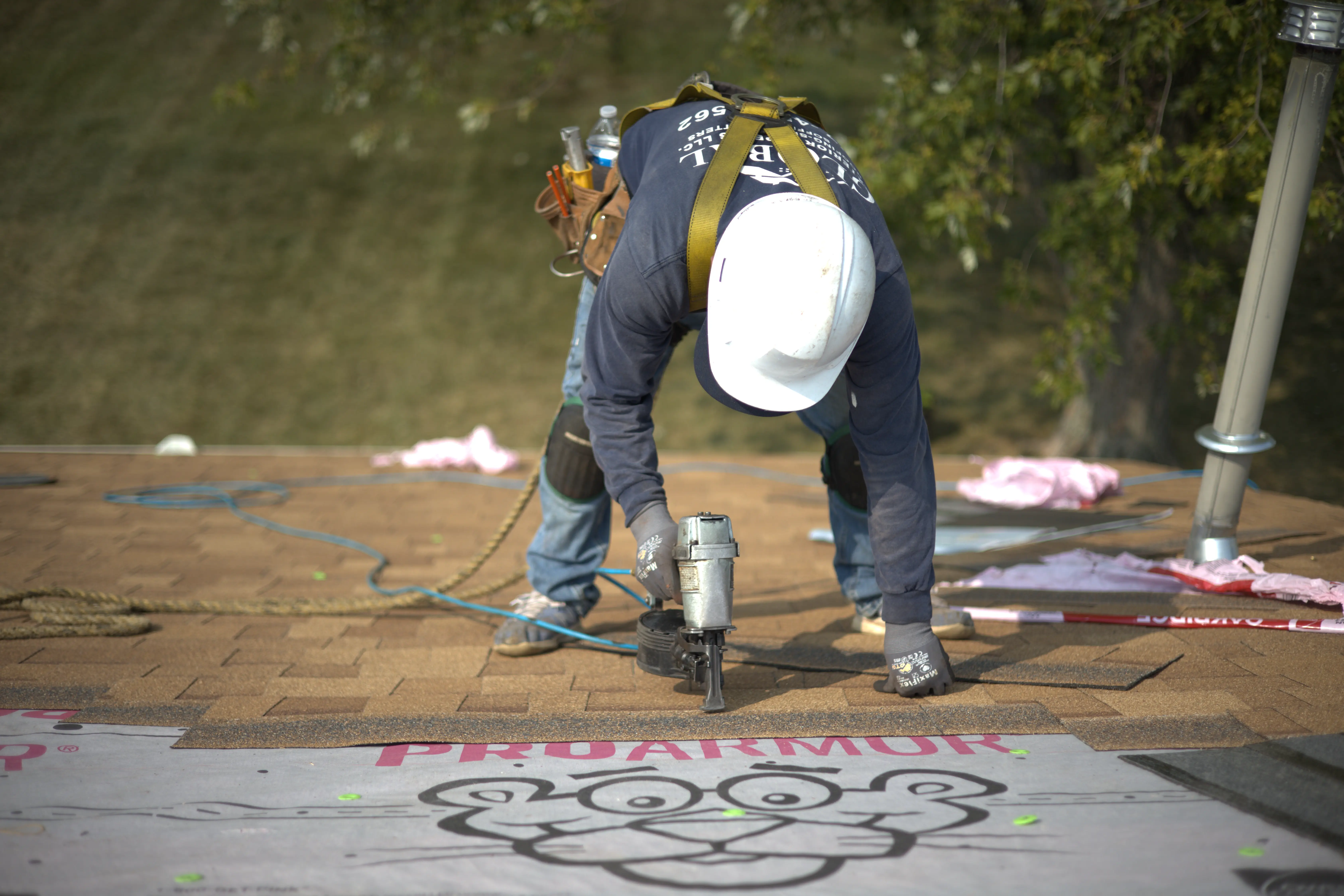 Global Exterior Experts Roofer Installing Shingle Roof On Residential Home