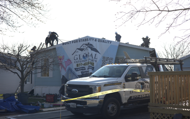 Global Exterior Experts Roofers Ontop of Residential Roof With Global Exterior Experts Tarp Layed Down