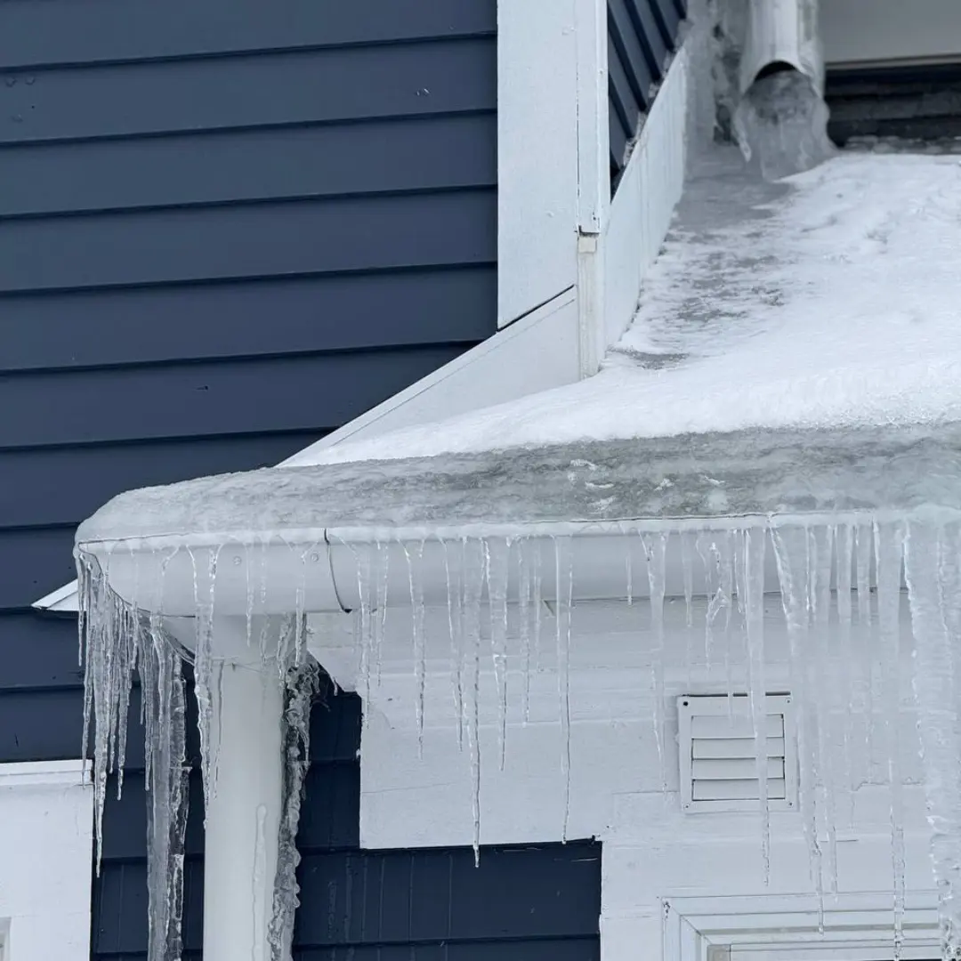 Gutters and Downspouts filled with ice from ice dam