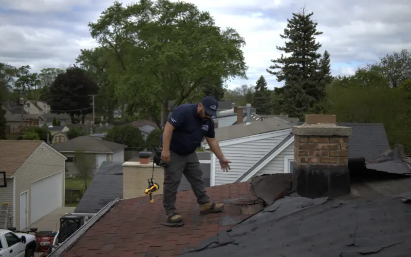 Aaron Venegaz Inspecting A Damaged Roof
