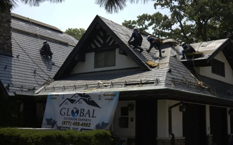 4 Roofers Installing A Slate Roof On A Residential Home