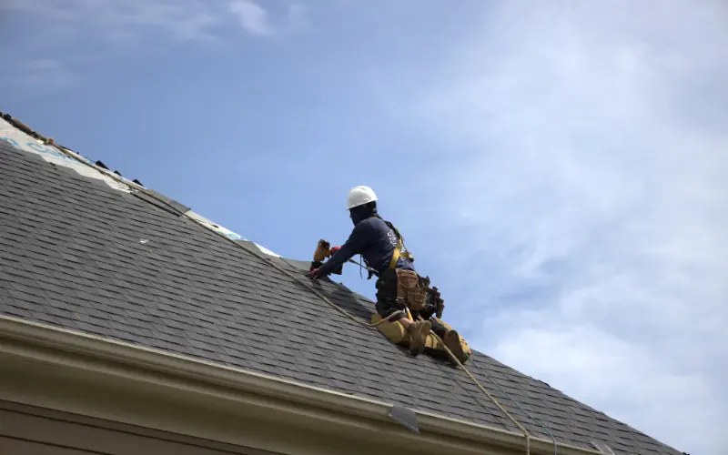 Global Exterior Experts Roofer Installing Shingles Onto Residential Roof