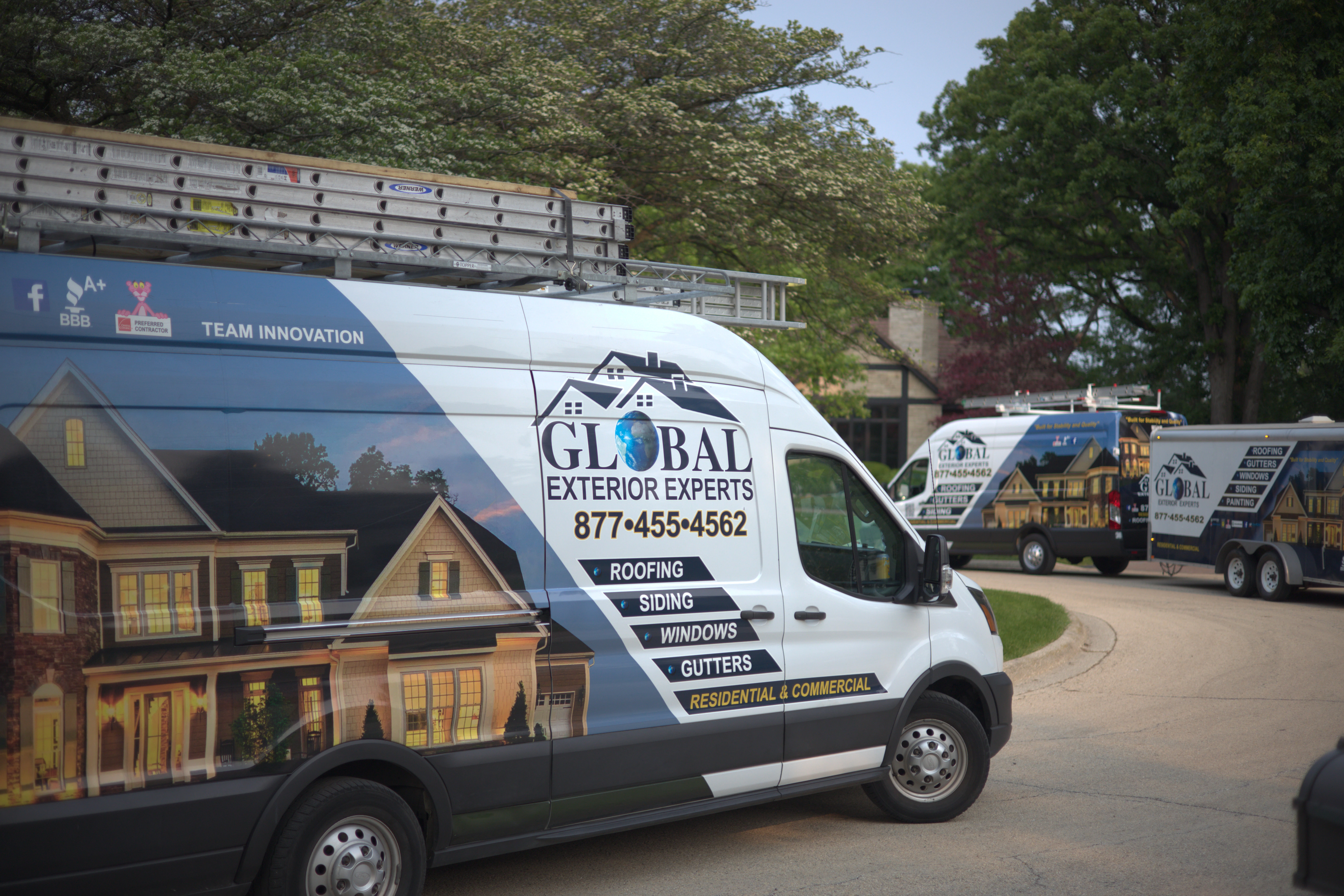 Global Exterior Expert Vans & Trucks With Trailers Infront Of Residential Roof Project