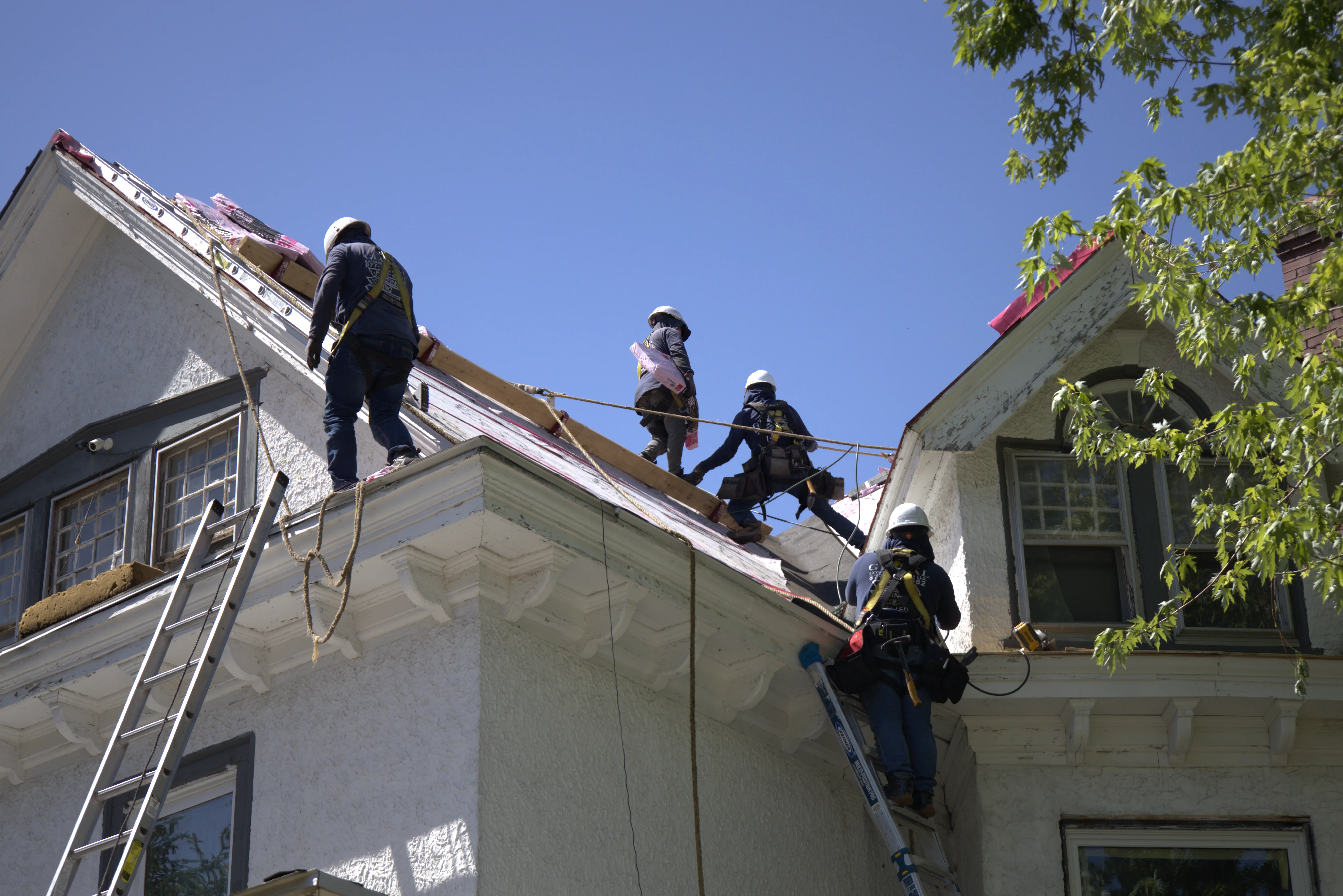 Roofers Installing Roof On Residential Home
