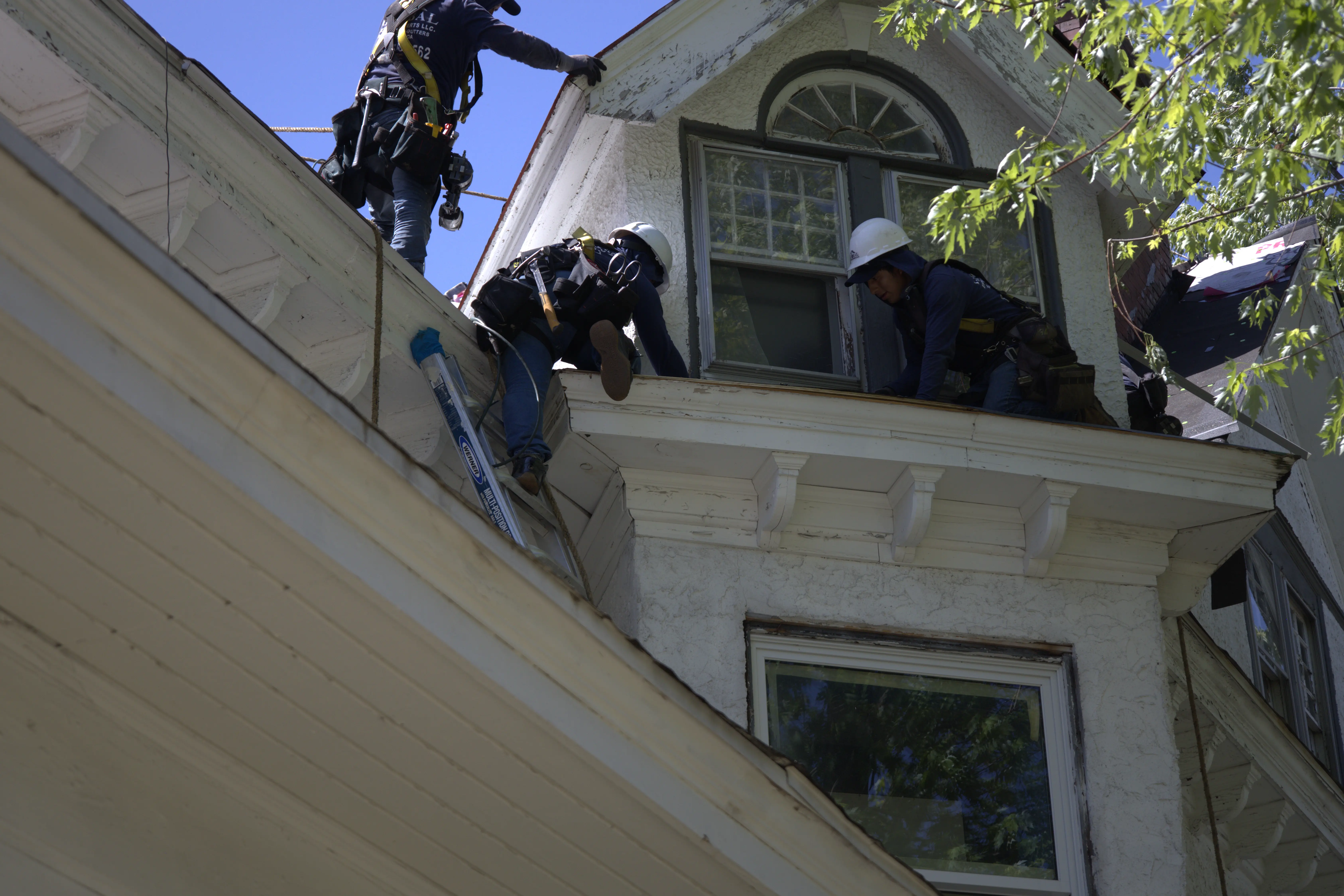 Roofers Installing Roof On Historic Home