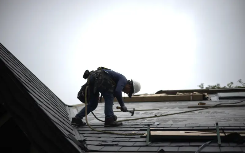 Global Exterior Experts Roofer Installing Slate Roofing On Residential Home