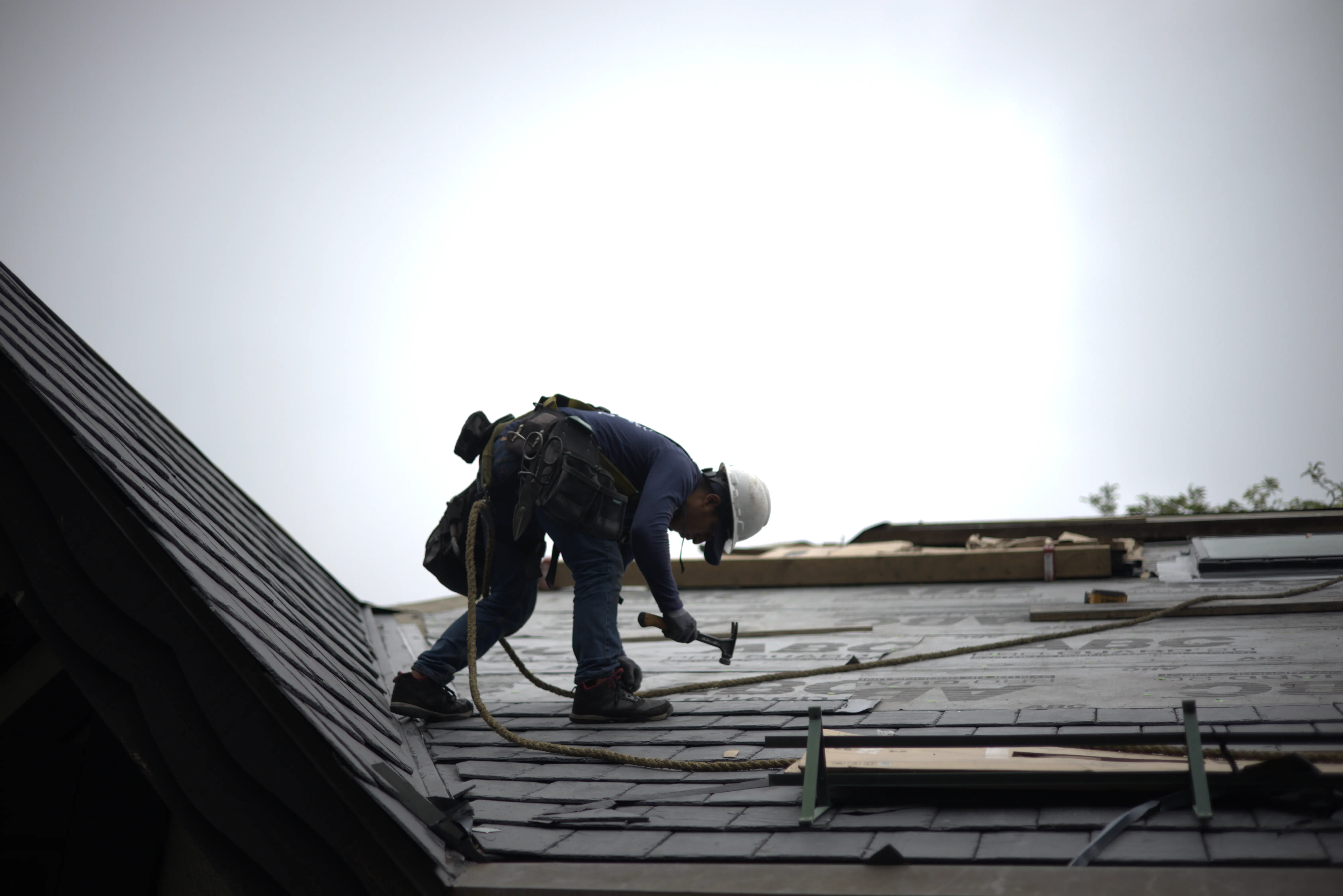 Global Exterior Experts Roofer Installing Slate Roofing On Residential Home