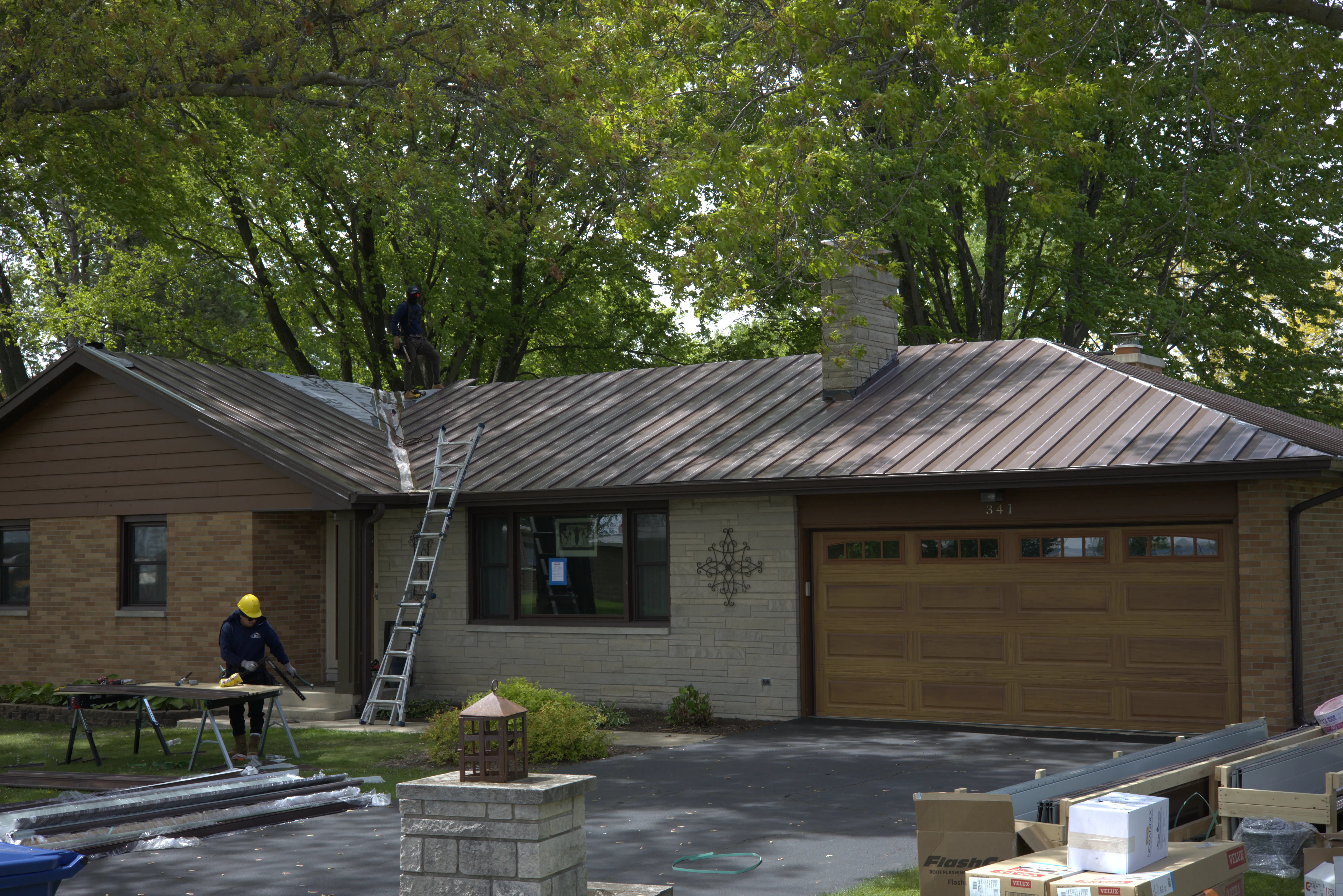 Brown Metal Roof Being Installed On One Story Residential Home