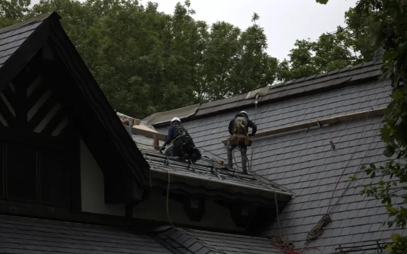 Roofers Installing Slate On Home