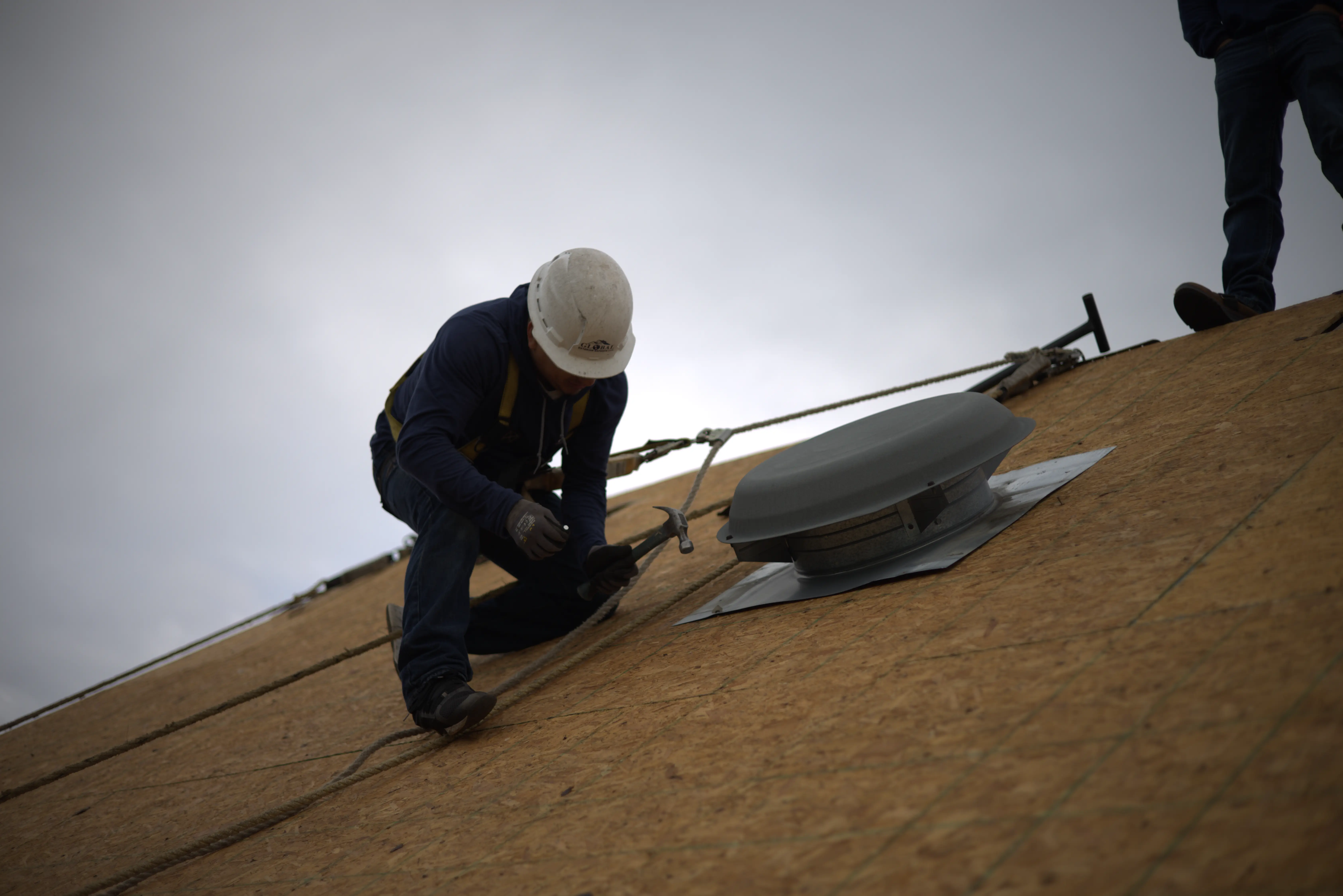 Roofer Putting In Roof Vent To Build The Roof System