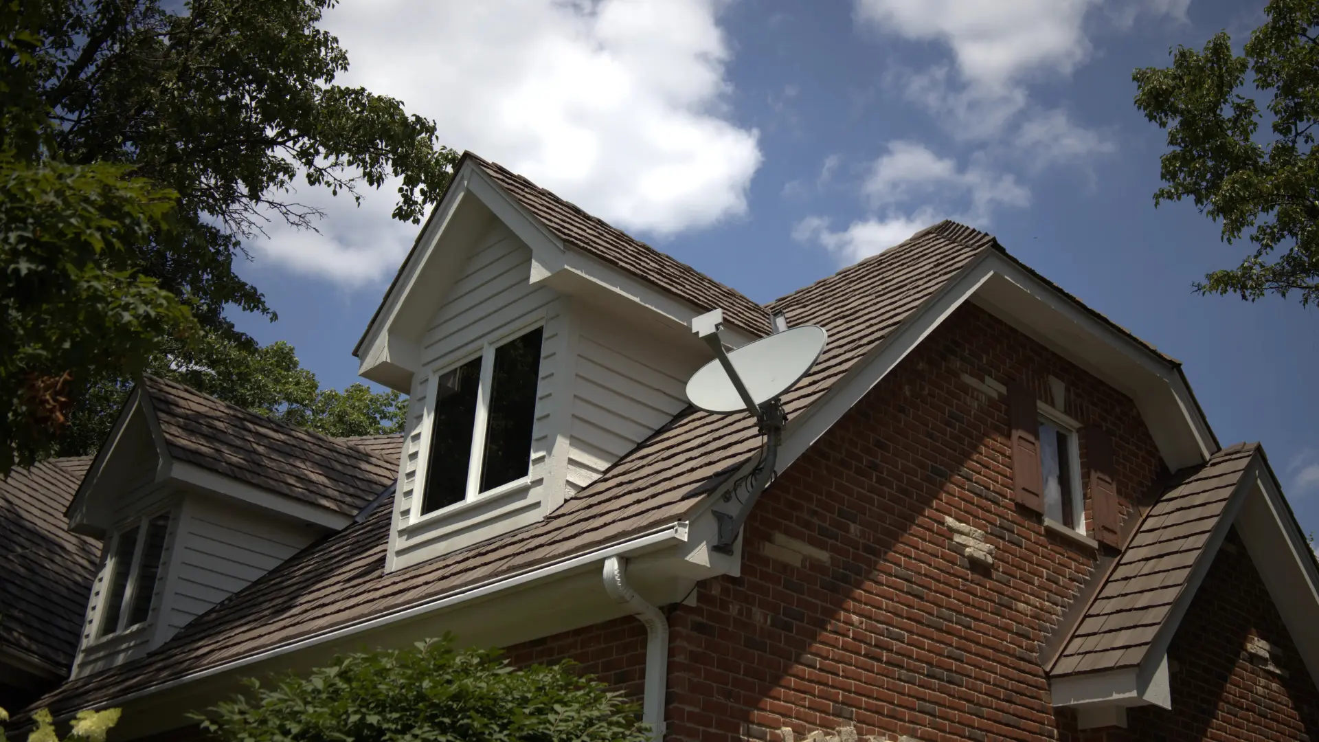 Residential Home With Brown Synthetic Shake On It