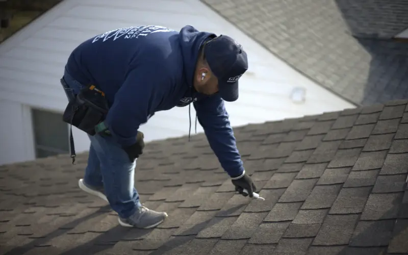 Professional Roofer Inspecting A Residential Property For Hail and Wind Damage