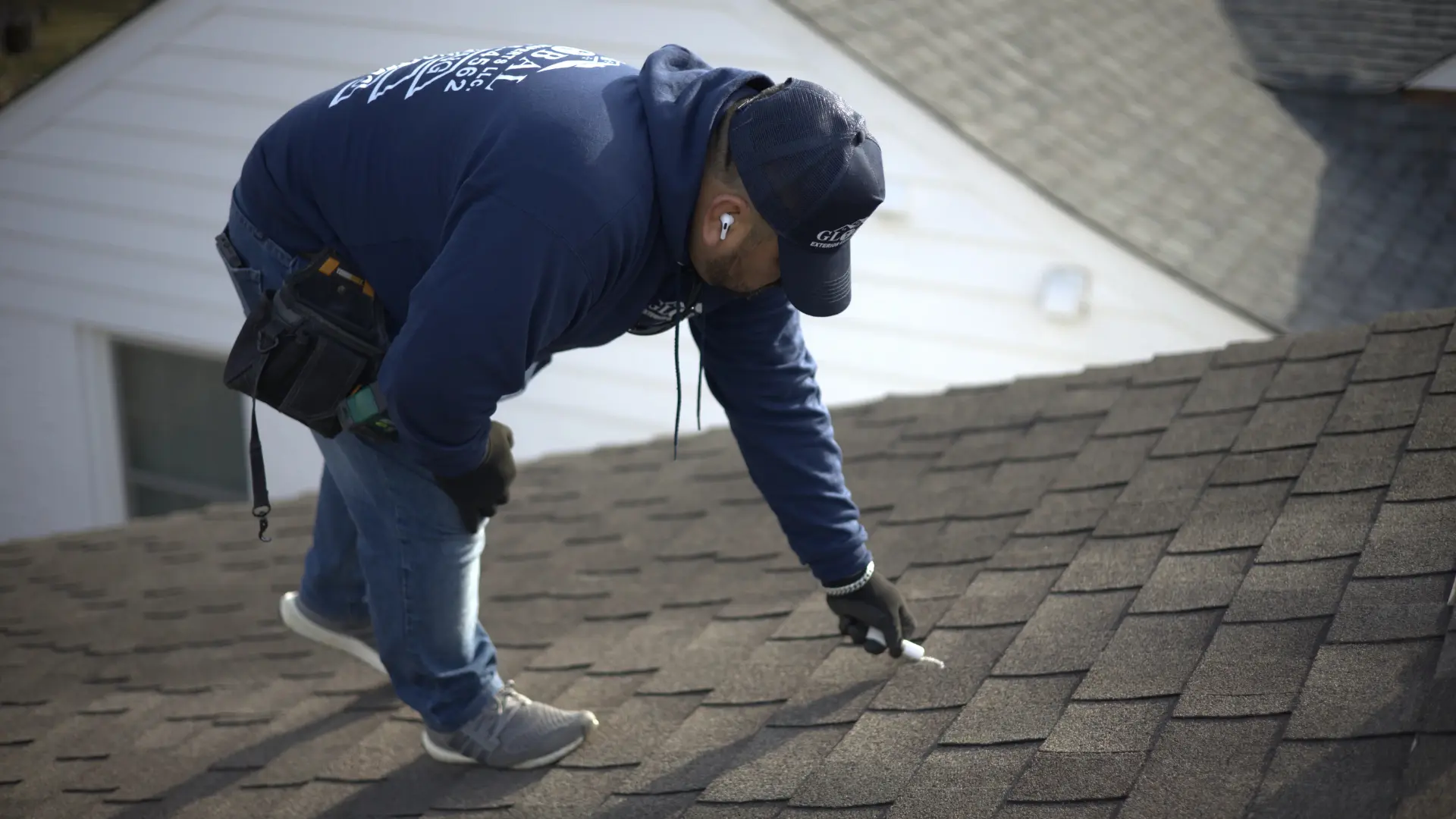 Professional Roofer Inspecting A Residential Roof For Hail and Wind Damaage