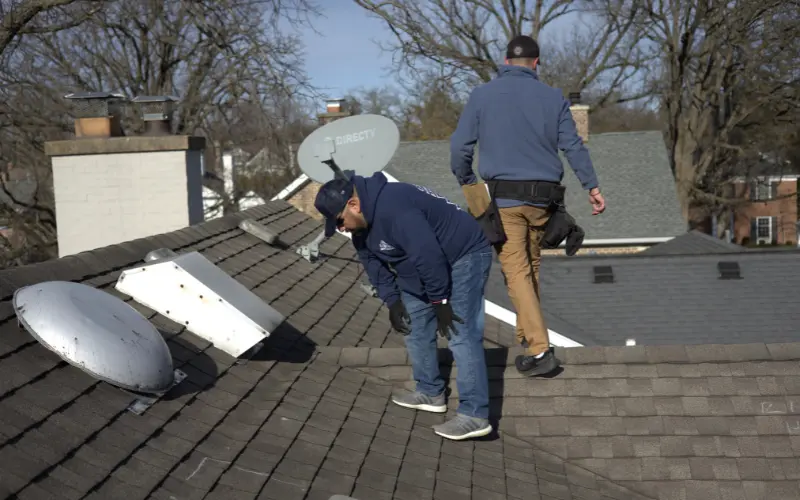 Roof Inspection By Professional Roofer Checking For Hail Damage