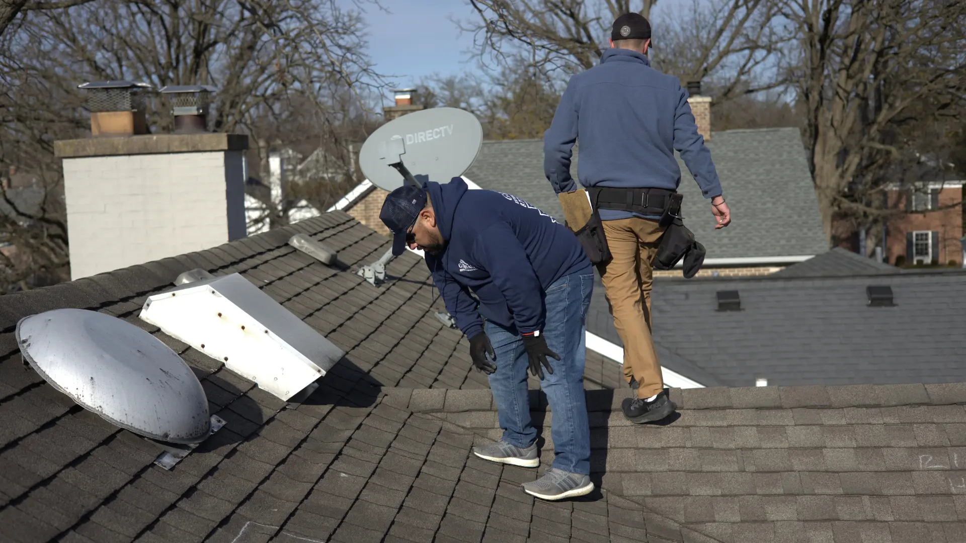 Roofer Checking Roof For Storm Damage