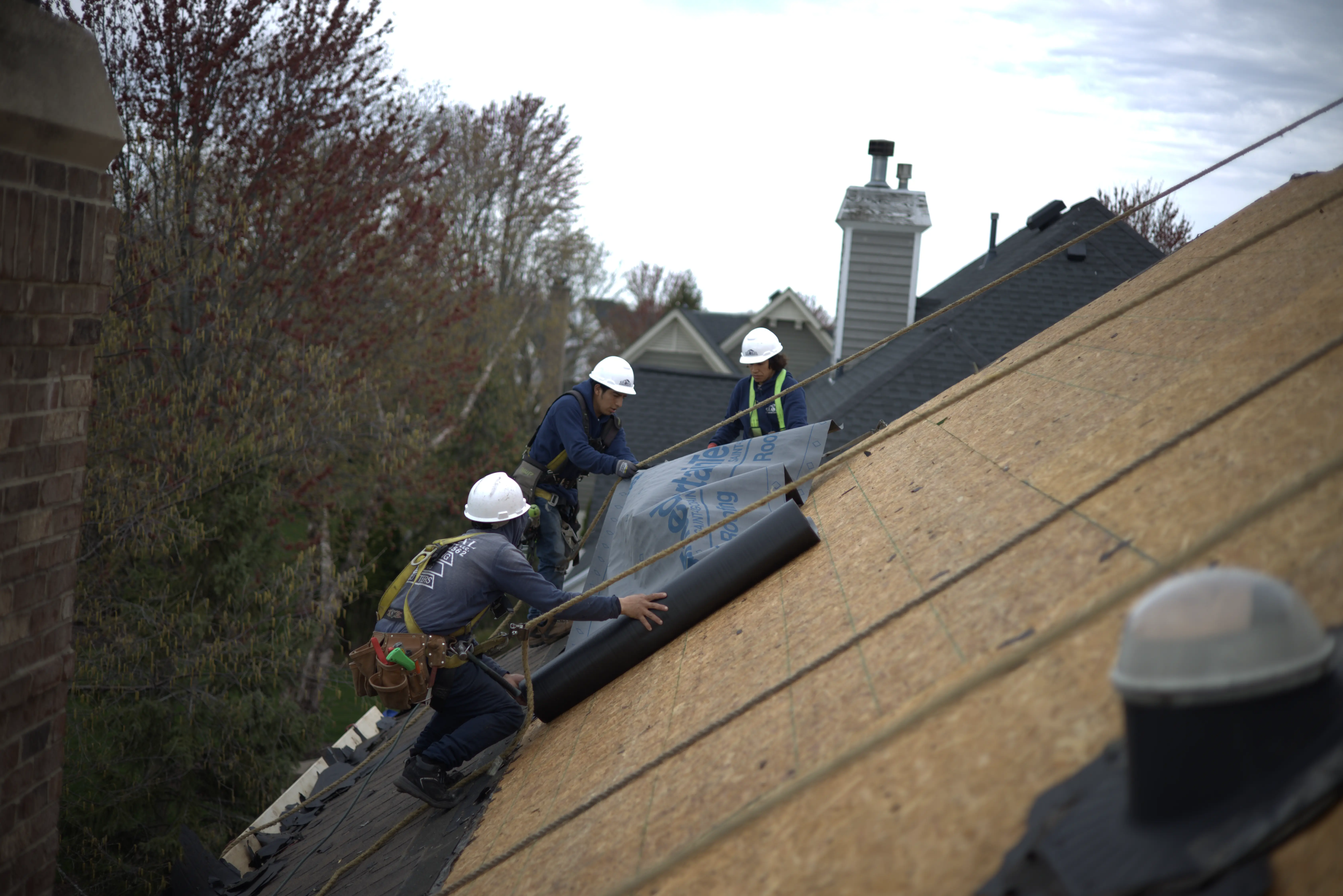 Roofers Installing Underlayment