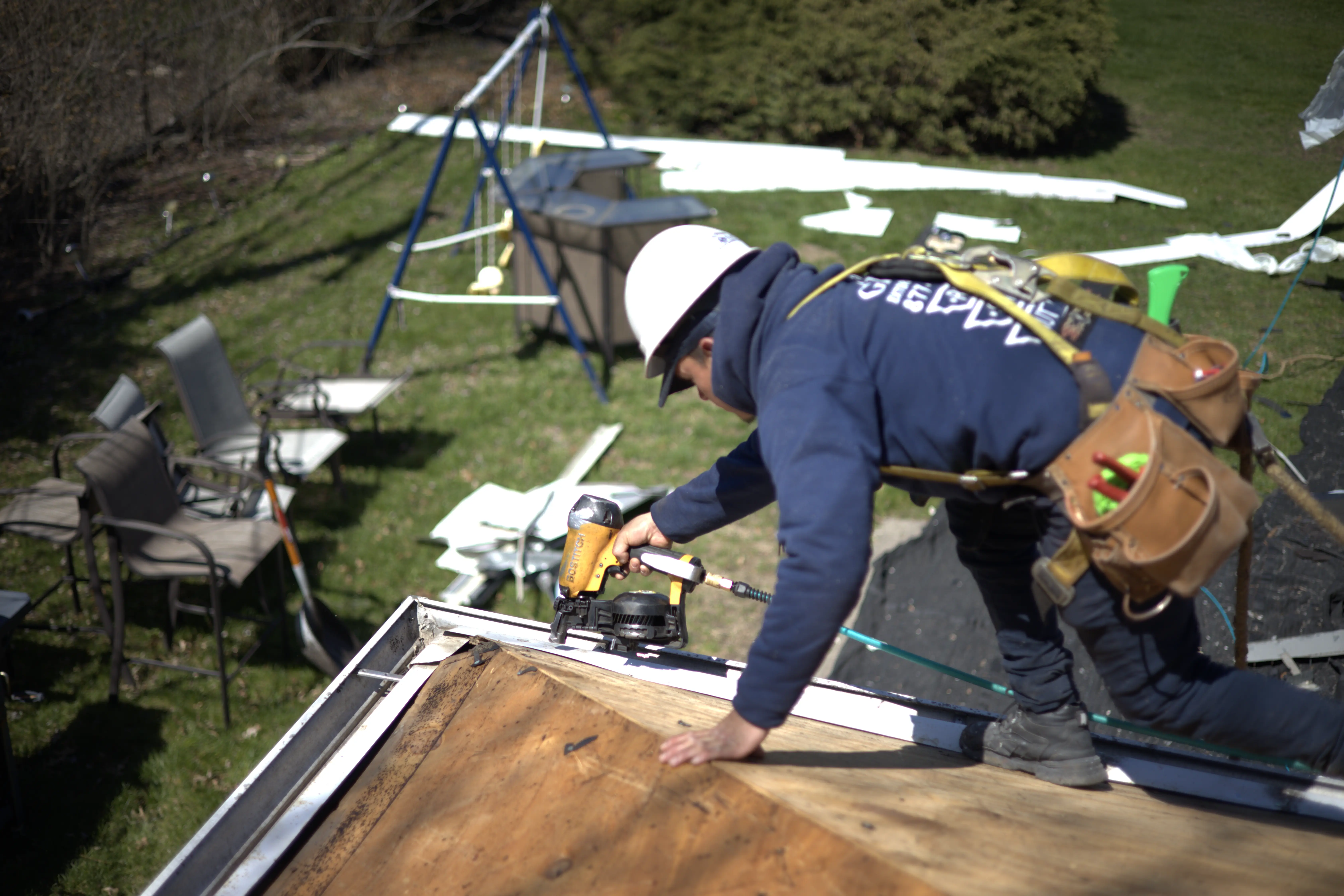 Roofer Installing Drip Edge On Residential Home