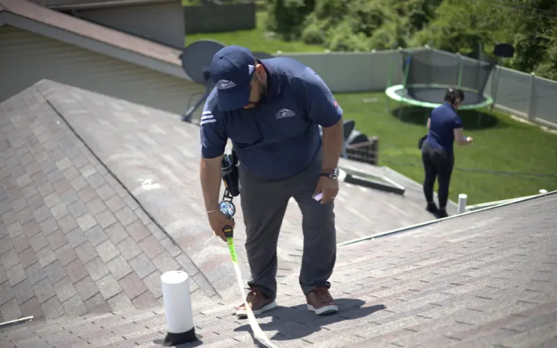 Measuring Roof During Roof Inspection
