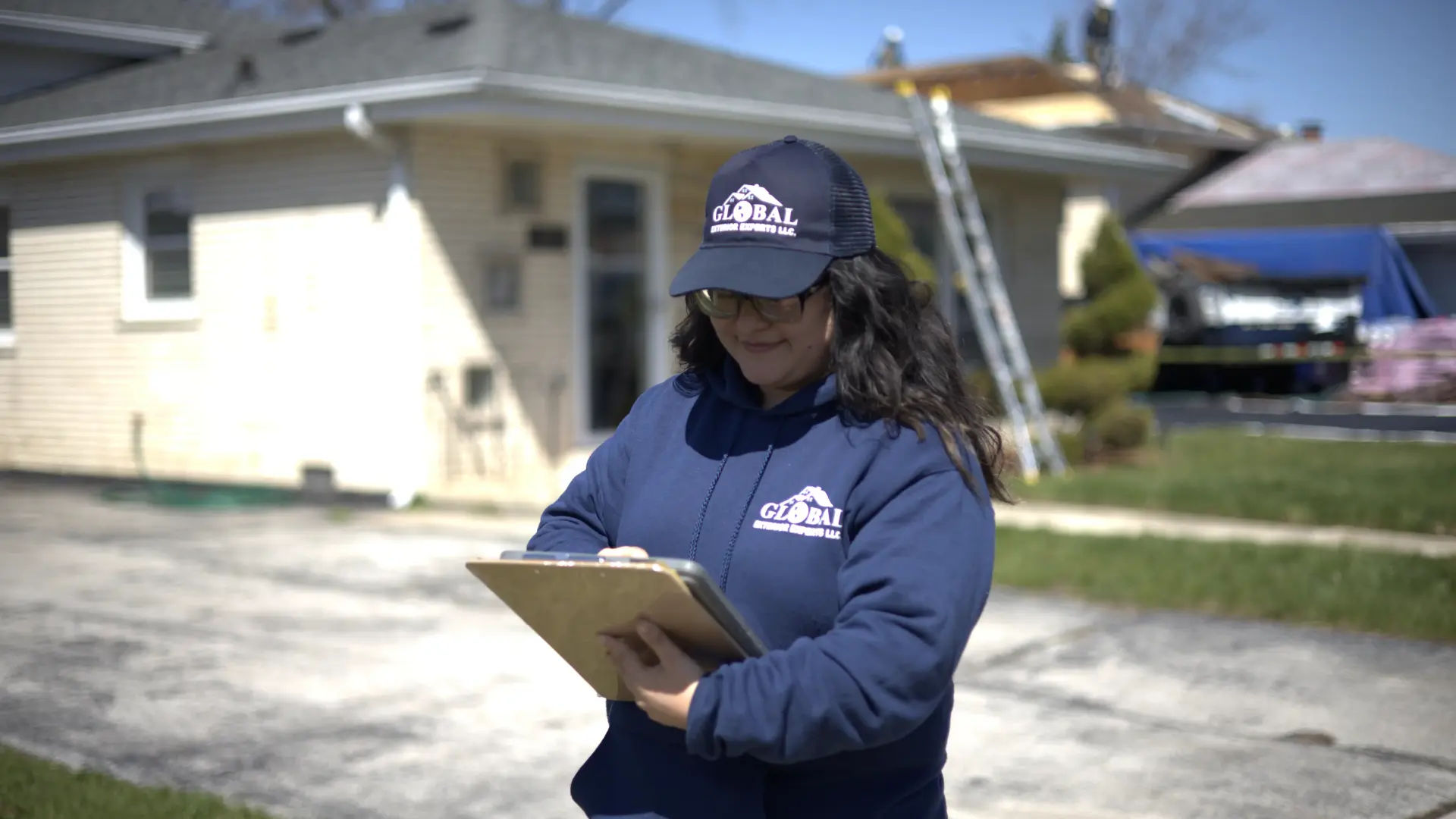 Global Exterior Experts Team Member doing roof inspection from ipad