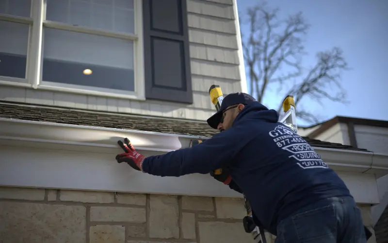 Aaron inspecting gutters on residential home